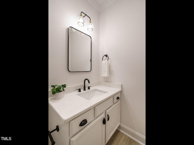 bathroom featuring ornamental molding, vanity, and hardwood / wood-style floors