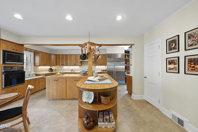 kitchen featuring pendant lighting, a center island, ornamental molding, black appliances, and decorative backsplash