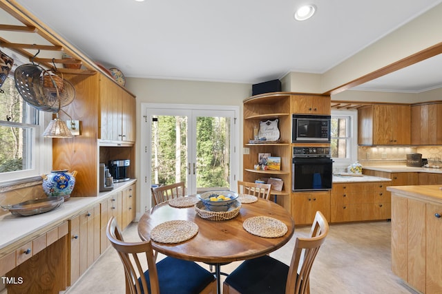 dining room with crown molding, plenty of natural light, and french doors