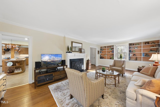 living room featuring hardwood / wood-style flooring, ornamental molding, and a notable chandelier