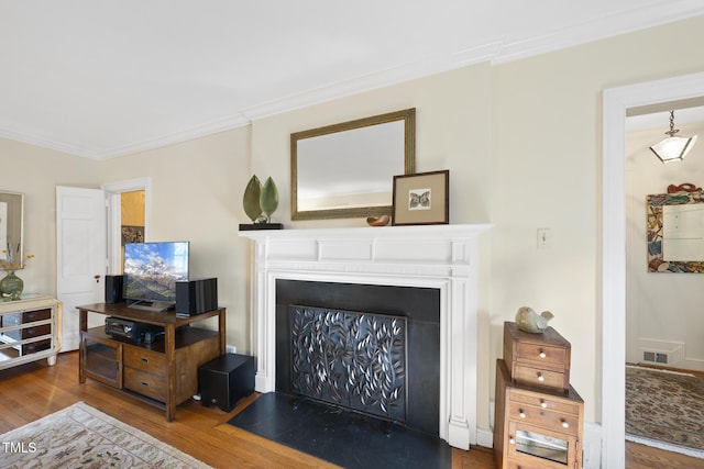 living room with ornamental molding and hardwood / wood-style floors