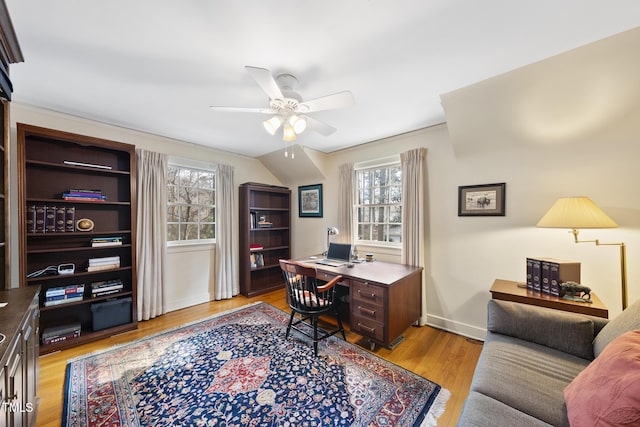 home office featuring light hardwood / wood-style flooring and ceiling fan