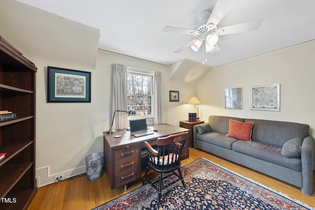 home office with ceiling fan, vaulted ceiling, and light wood-type flooring