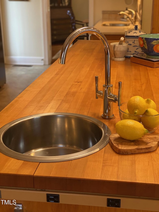 interior details featuring butcher block counters and sink