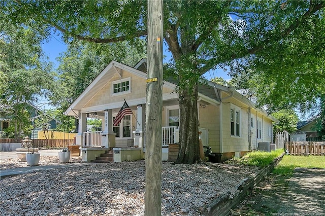 view of side of property with a porch and central AC unit