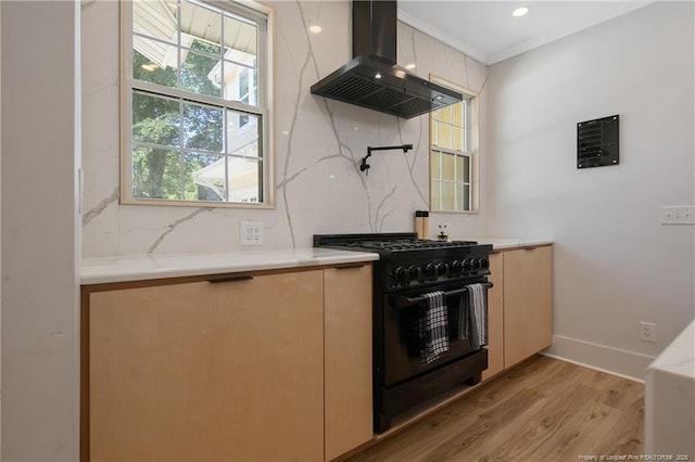 kitchen featuring crown molding, light hardwood / wood-style flooring, black range with gas stovetop, decorative backsplash, and exhaust hood