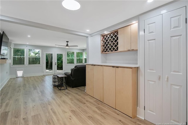 living room featuring light hardwood / wood-style flooring, ceiling fan, and french doors