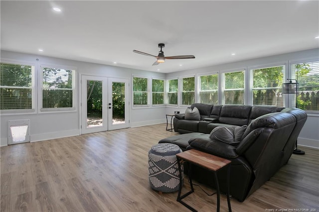 living room featuring french doors, ceiling fan, plenty of natural light, and light hardwood / wood-style flooring