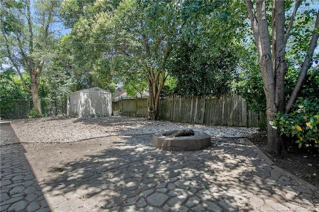 view of patio / terrace with a shed and an outdoor fire pit