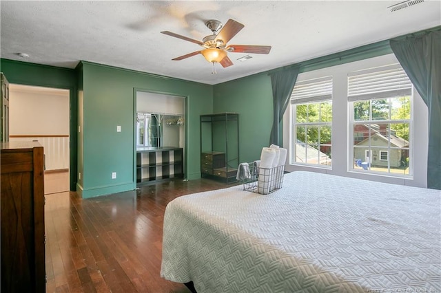 bedroom with ceiling fan and dark hardwood / wood-style floors