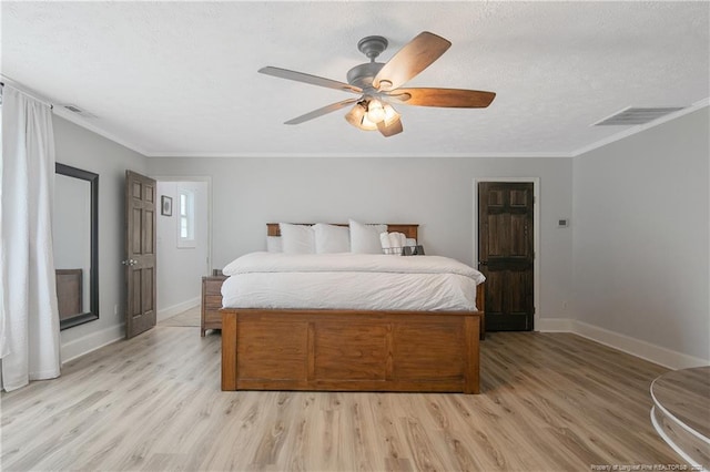 bedroom with crown molding, ceiling fan, light hardwood / wood-style flooring, and a textured ceiling