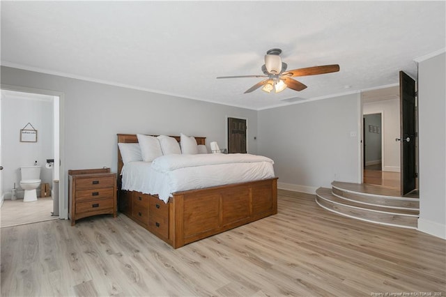 bedroom featuring ornamental molding, ceiling fan, light hardwood / wood-style floors, and ensuite bath