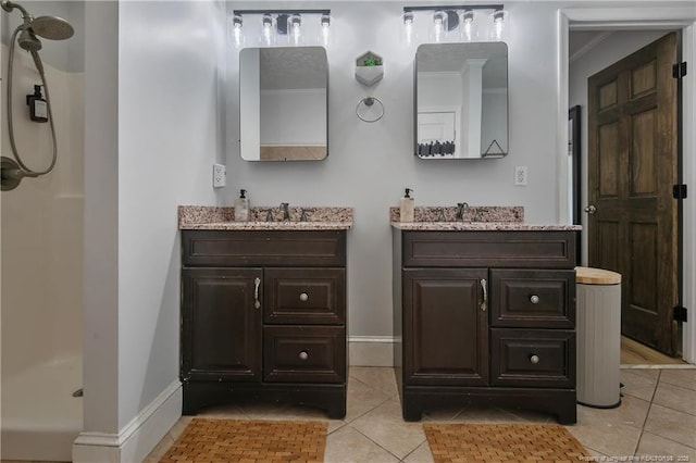 bathroom with vanity, tile patterned flooring, and a shower