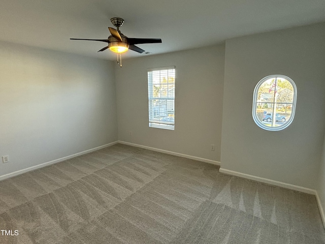 carpeted empty room featuring ceiling fan