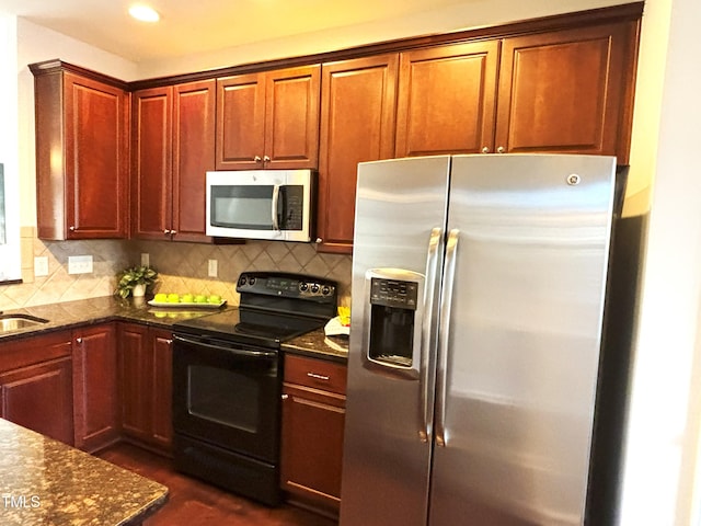 kitchen featuring tasteful backsplash, stainless steel appliances, dark hardwood / wood-style floors, and dark stone countertops