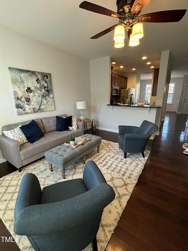 living room with wood-type flooring and ceiling fan