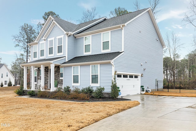 view of front facade with a garage, a front yard, and covered porch