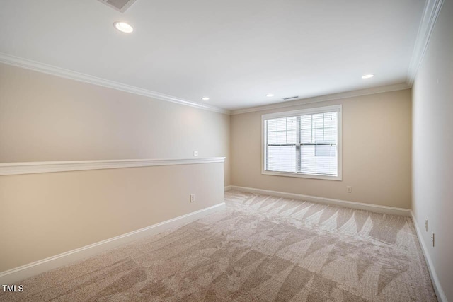 carpeted empty room featuring crown molding