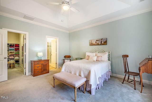 bedroom featuring ceiling fan, ornamental molding, light carpet, a spacious closet, and a raised ceiling