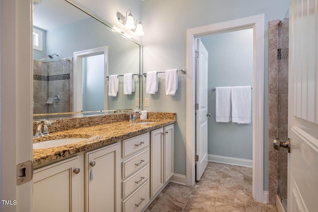 bathroom featuring tile patterned flooring, vanity, and a shower with shower door