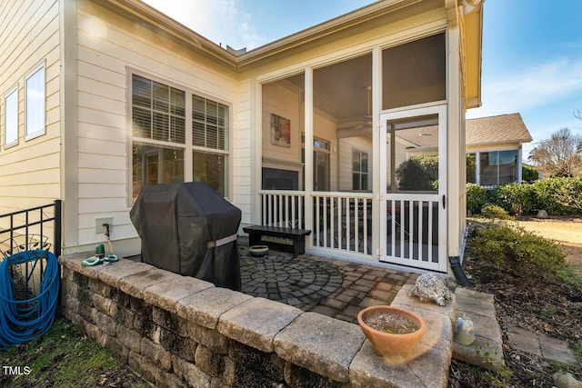 view of patio / terrace featuring a sunroom and grilling area