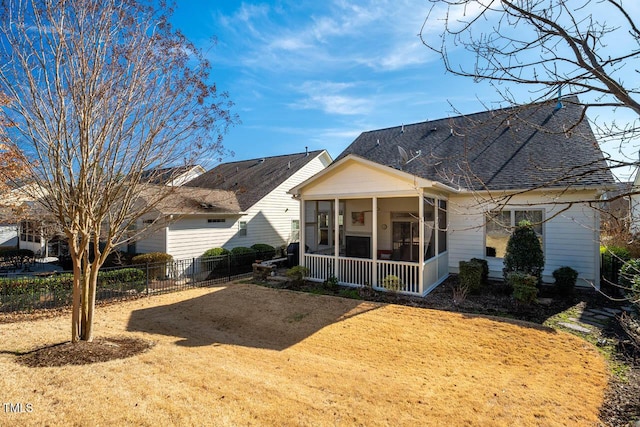 rear view of property with a sunroom