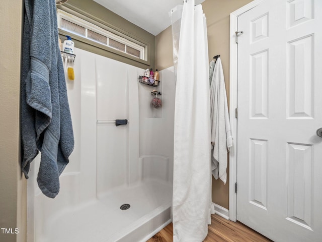 bathroom with a shower with curtain and hardwood / wood-style flooring