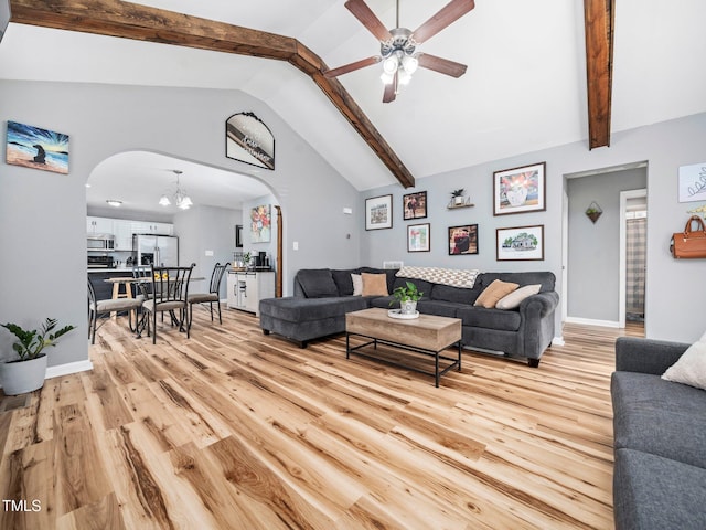 living room with high vaulted ceiling, beam ceiling, light hardwood / wood-style floors, and ceiling fan