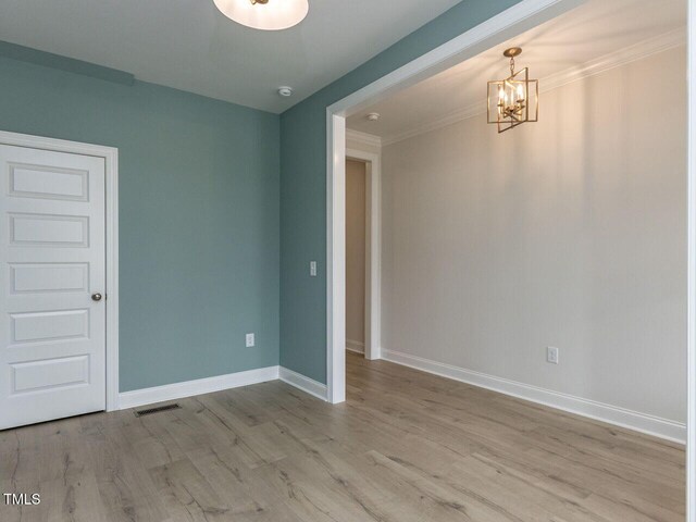 1813 Bright Lantern Way, Wendell, NC 27591 - unfurnished room featuring a chandelier, baseboards, wood finished floors, ornamental molding, and a smoke detector
