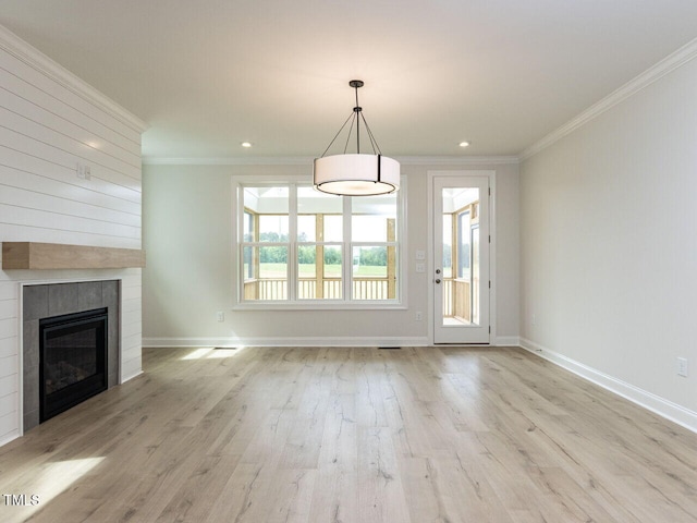 1813 Bright Lantern Way, Wendell, NC 27591 - unfurnished living room featuring ornamental molding, wood finished floors, baseboards, a tiled fireplace, and recessed lighting