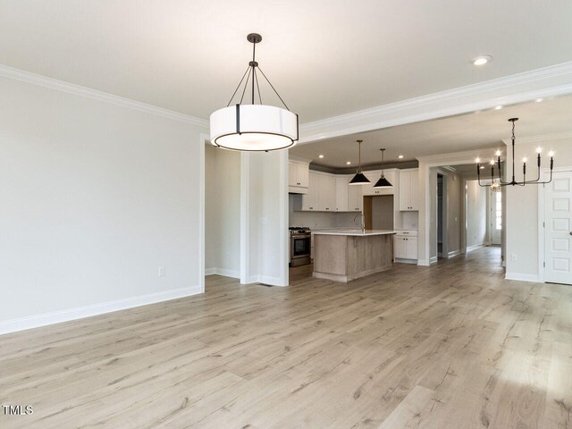 1813 Bright Lantern Way, Wendell, NC 27591 - unfurnished living room featuring ornamental molding, a chandelier, baseboards, light wood-style flooring, and recessed lighting