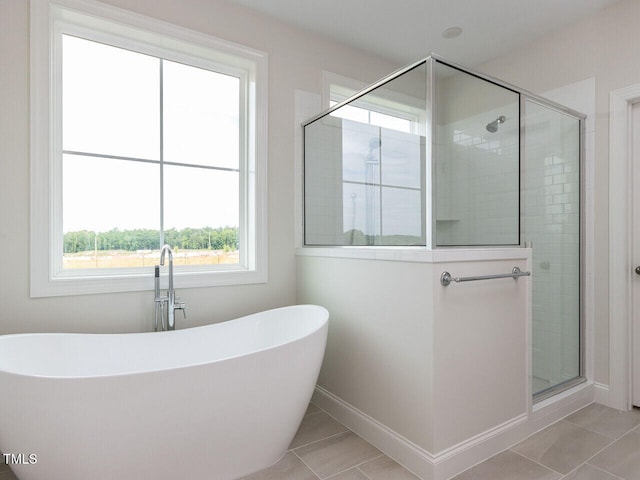 1813 Bright Lantern Way, Wendell, NC 27591 - full bathroom featuring tile patterned flooring, a stall shower, a soaking tub, and baseboards
