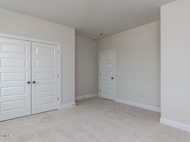 1813 Bright Lantern Way, Wendell, NC 27591 - unfurnished bedroom featuring carpet, a closet, and baseboards