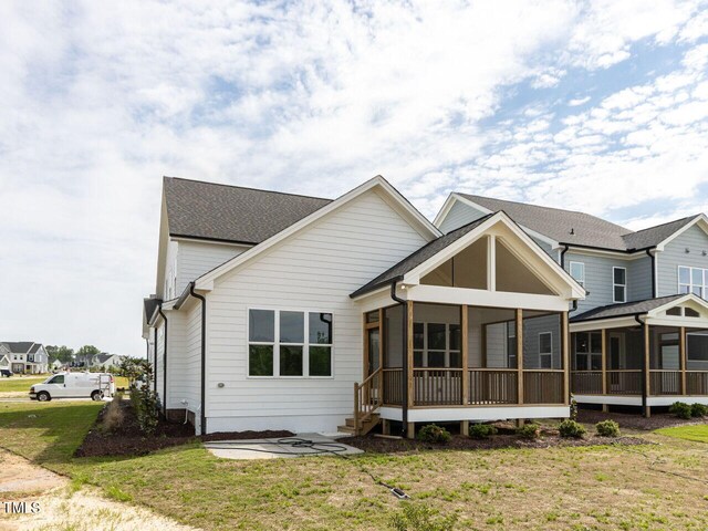 1813 Bright Lantern Way, Wendell, NC 27591 - rear view of property with a sunroom, a yard, and a shingled roof