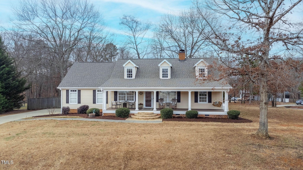 cape cod home with a front lawn and a porch