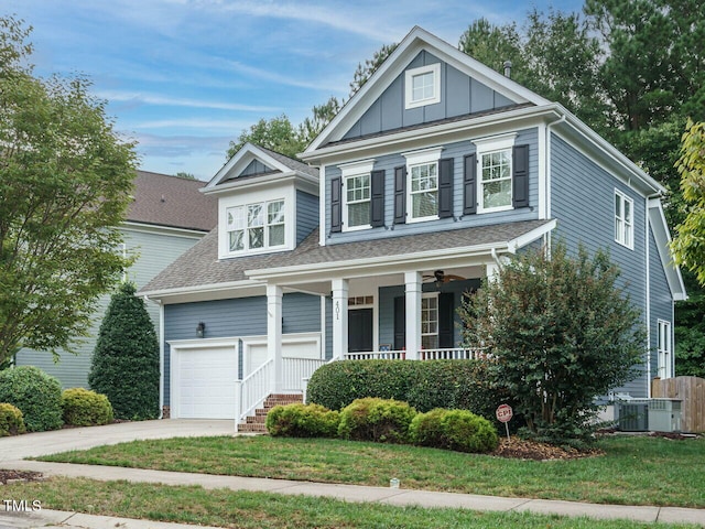 view of front facade with a garage, a front lawn, and a porch