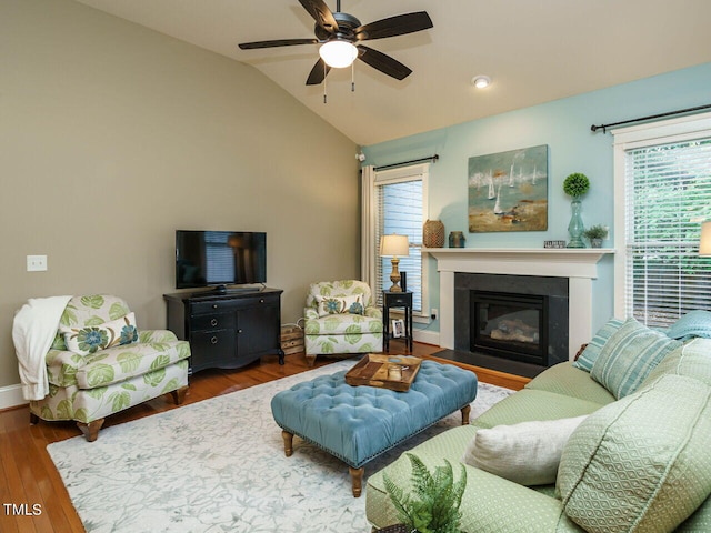 living room featuring lofted ceiling, ceiling fan, plenty of natural light, and wood-type flooring