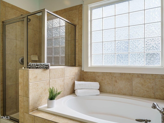 bathroom featuring separate shower and tub