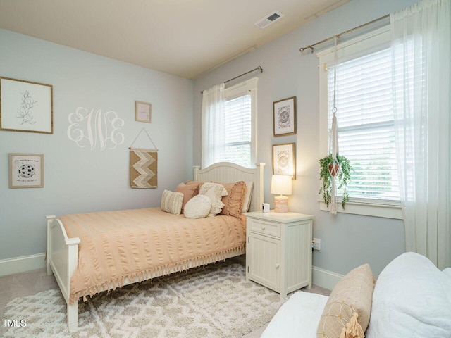 bedroom featuring light colored carpet