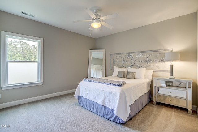 bedroom with light carpet and ceiling fan