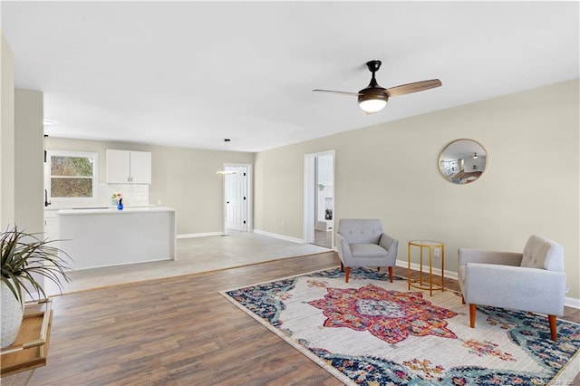 living area featuring ceiling fan and light wood-type flooring