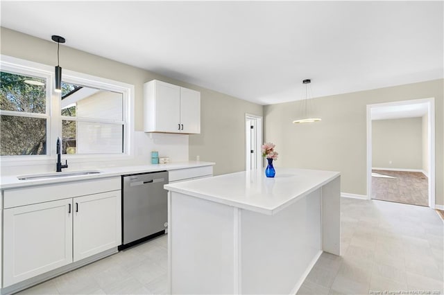 kitchen with sink, white cabinetry, dishwasher, a kitchen island, and pendant lighting