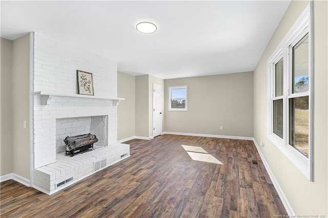 unfurnished living room with a fireplace and dark hardwood / wood-style flooring