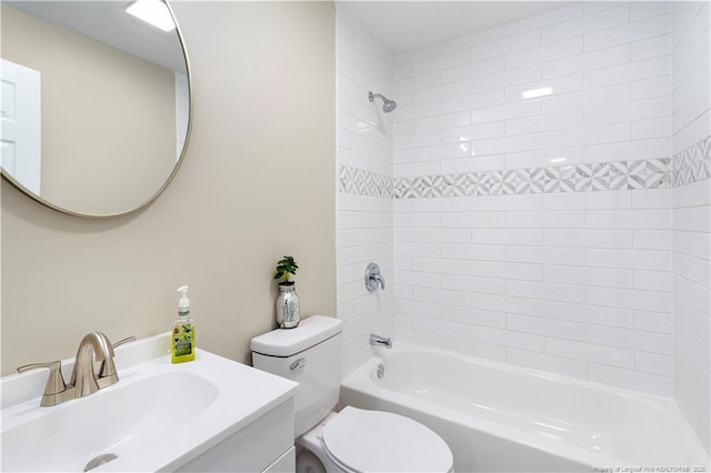 full bathroom with tiled shower / bath combo, vanity, and toilet