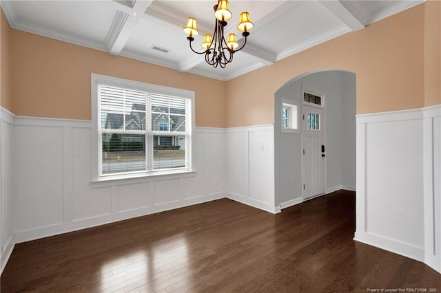 spare room with coffered ceiling, dark hardwood / wood-style floors, beam ceiling, and a notable chandelier