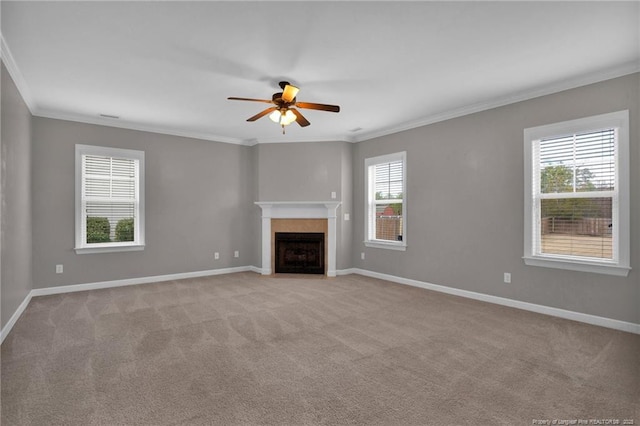 unfurnished living room with ceiling fan, ornamental molding, light carpet, and a wealth of natural light