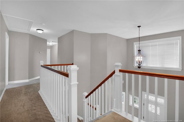 corridor featuring carpet floors and a chandelier