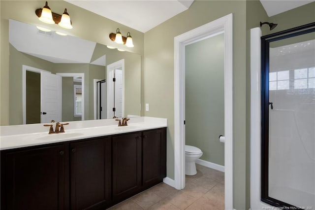 bathroom featuring vanity, toilet, a shower with shower door, and tile patterned flooring