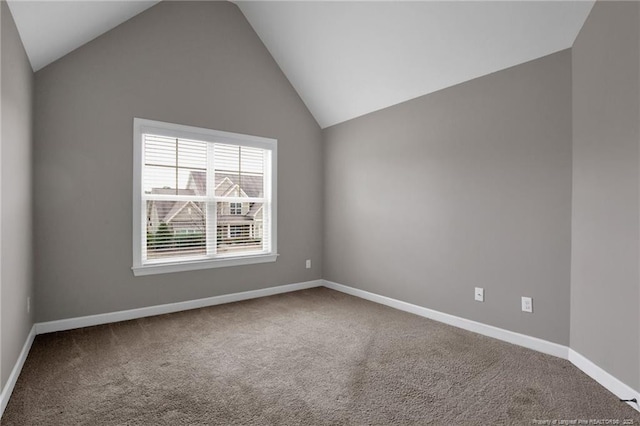 unfurnished room with vaulted ceiling and carpet floors