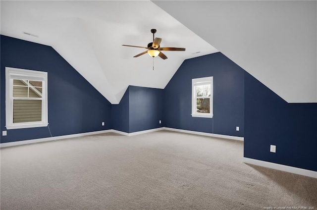 additional living space with vaulted ceiling, carpet flooring, and ceiling fan